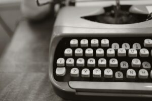 Detailed close-up of a vintage typewriter keyboard in black and white.