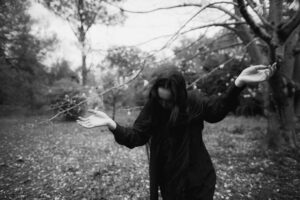 Monochrome portrait of a woman in nature with an artistic vibe.